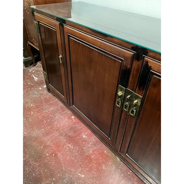 This vintage Chinese rosewood sideboard is a timeless statement piece that seamlessly blends authentic Chinoiserie style...