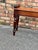 This is an 19th century wood hall bench in English with delicately hand carved rolled arms. Its solid construction, peg...