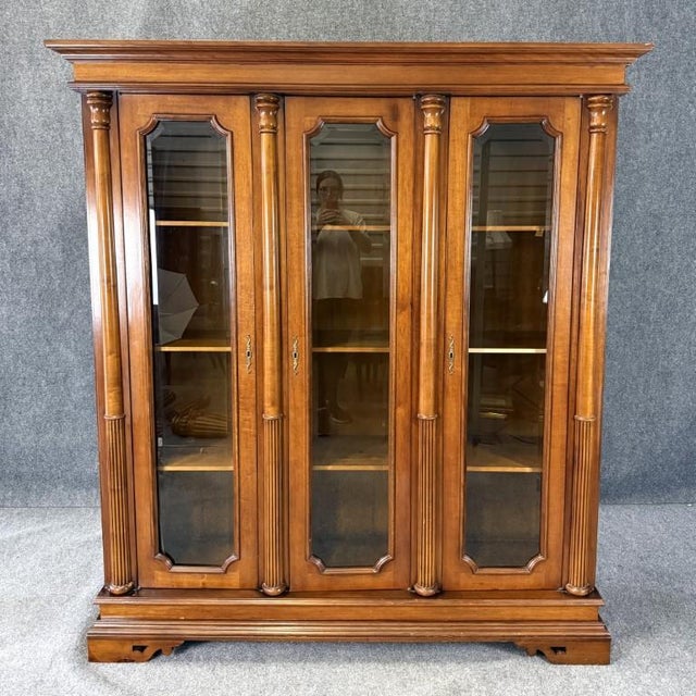 This monumental 3-door library bookcase features an impressive architectural form with fluted columns, a substantial...