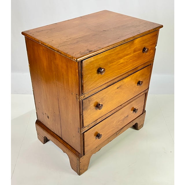 Authentic 19th-century antique pine chest of drawers. Featuring a classic three-drawer configuration, this piece showcases...