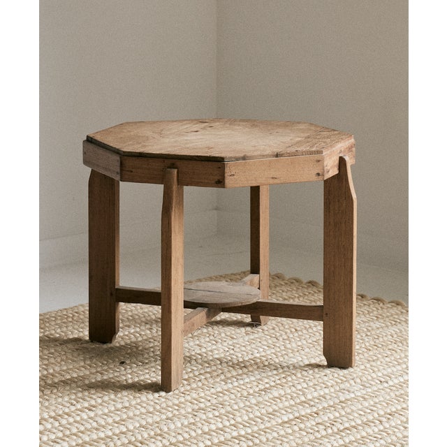 Vintage wooden side table, octagon shaped with four legs. This raw wood end table is from Belgium and was made in the...