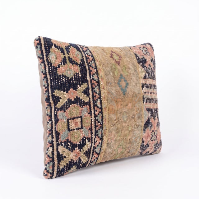 This 16'' x 24'' pillow cover was made from an authentic Turkish rug — geometric navy borders with blush florals and gold...