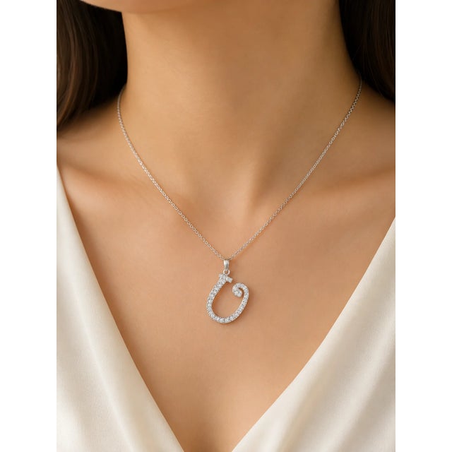 This modern 18K white gold pendant necklace features a "U" initial slide adorned with brilliant diamonds totaling 0.4...