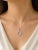 This modern 18K white gold pendant necklace features a "U" initial slide adorned with brilliant diamonds totaling 0.4...