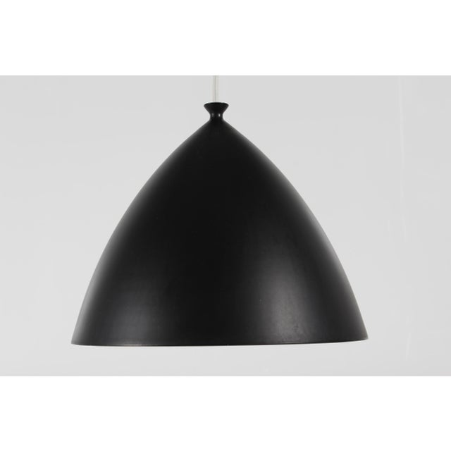 Vintage Scandinavian pendant manufactured ca 1960s. The lamp is shaped like a beautiful taut arc with a nice detailing on...