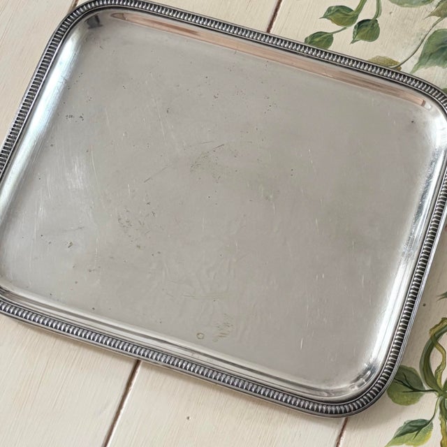 This vintage French silver-plated serving tray beautifully blends timeless elegance with classic European craftsmanship....