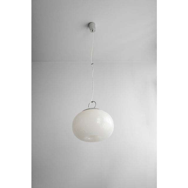 The Italian pendant lamp is made of hand-blown Murano glass by Mazzega. It has an organic shape and represents a typical...
