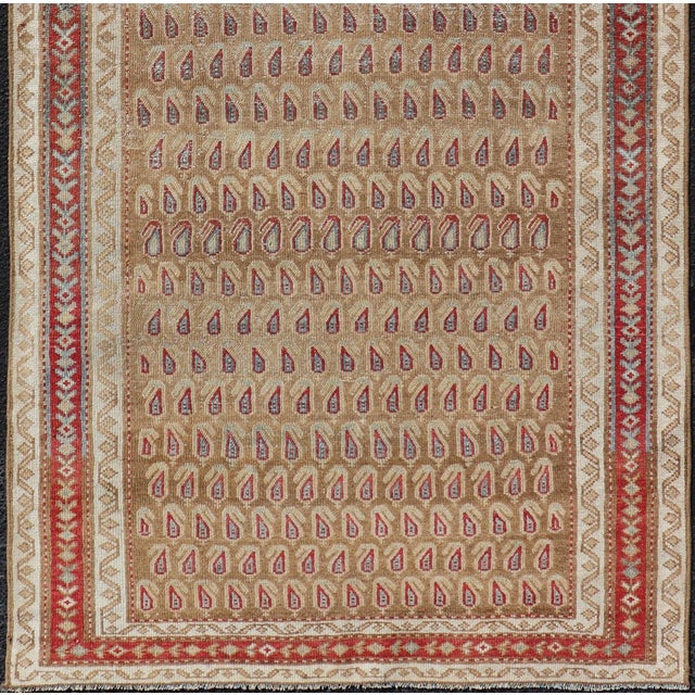 Measures: 3'4 x 7'4 This antique Persian Malayer features a paisley design atop a field of camel brown. The paisleys are...
