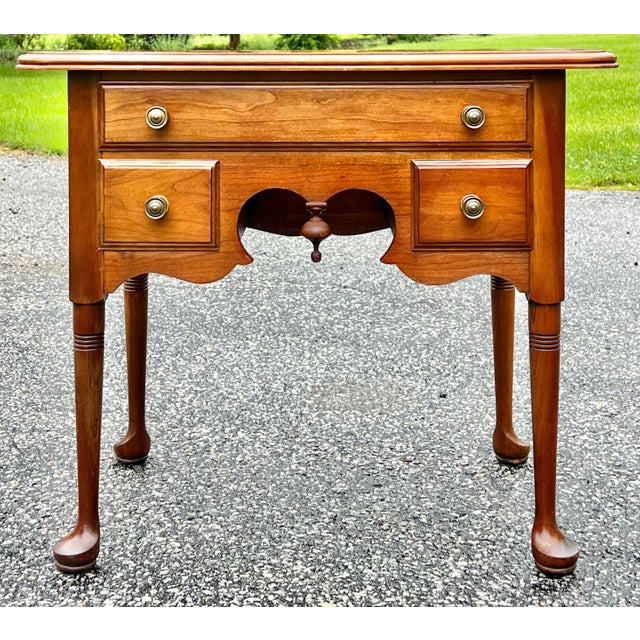 Lowboy style side table by Pennsylvania House. Crafted in solid cherry. Single full width top drawer with two small...