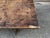 This is an antique rustic trestle bench (sometimes called a "water bench" or "fireside bench"), most likely dating from...