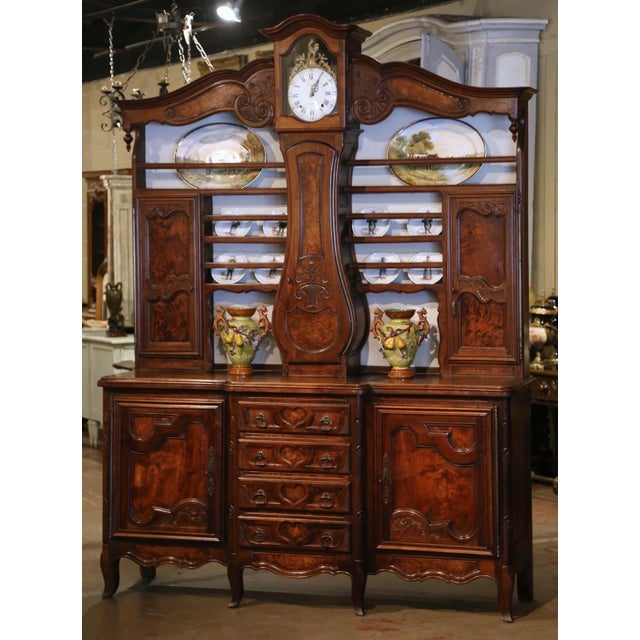 Crafted in the Bresse region near Lyon, France circa 1860, this impressive antique buffet à horloge combines a vaisselier,...