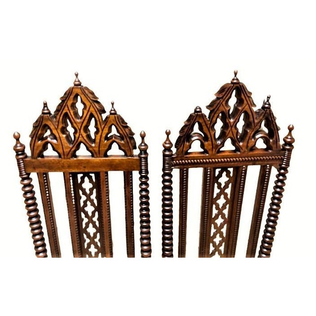 Exquisitely crafted Gothic Revival side chairs with new leather seat upholstery. Beautiful finish and details.