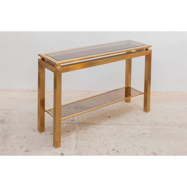 Set of two brass console tables, brass frame with fume glass top designed by Guy Lefevre for Maison Jansen, 1970`s,...