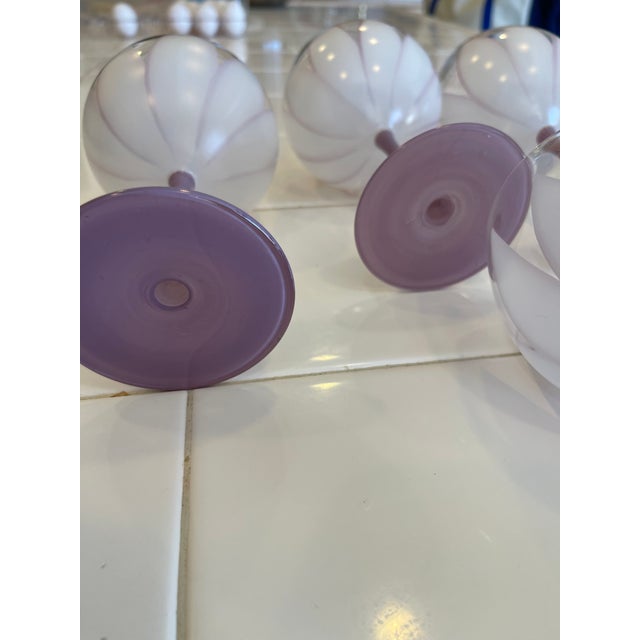 These goblets appear or look similar to lotus flowers. They are violet and different tones of violet five of them in total...