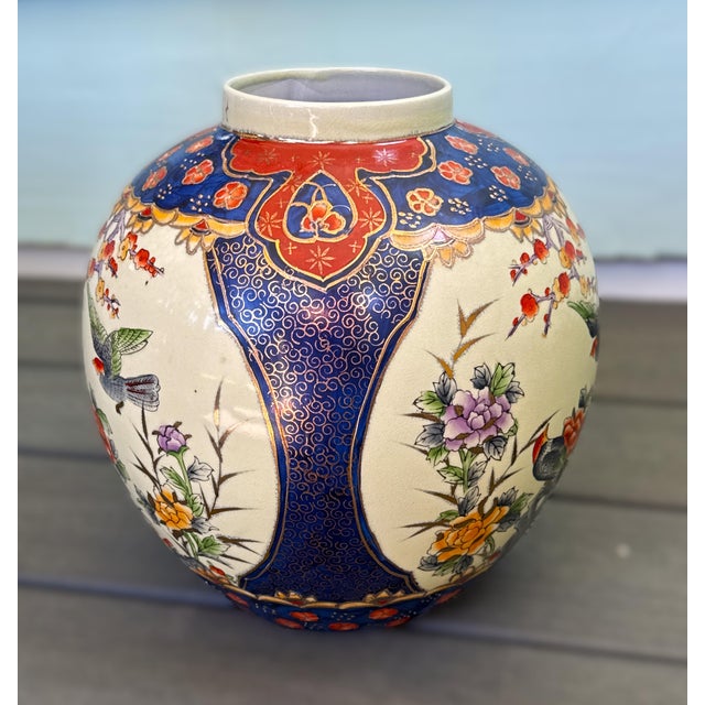 Striking hand‑painted Chinese porcelain ginger jar. 12 inches tall and decorated with an intricate scene of birds perched...