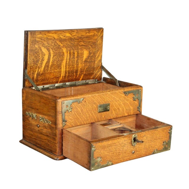 This distinguished oak and brass stationery box, crafted by Irish maker E.R. Moore & Co, combines practicality with...