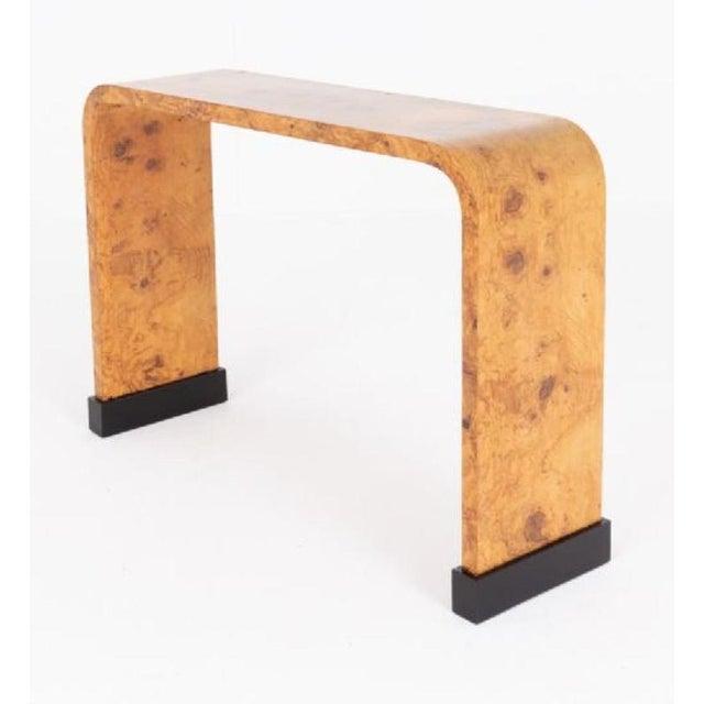 An elegant Art Deco console table of striking architectural form, beautifully crafted and raised upon bold ebonised plinth...