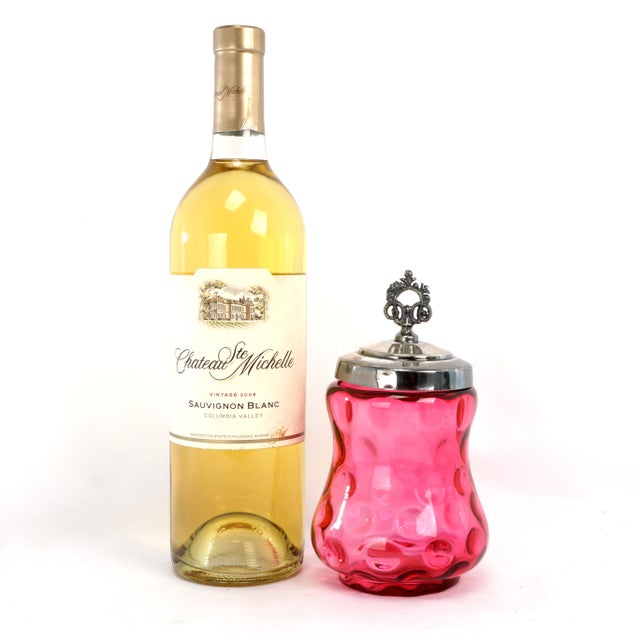 A lovely cranberry glass jam jar that you still can use to have jam with your toast. The molded cranberry glass jar has a...