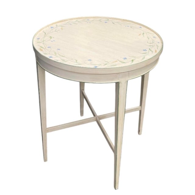This charming vintage accent table brings classic French Provincial elegance and soft, artisanal detail into any room....