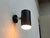 Minimalist wall lights by beisl. a functional design with a minimalist aesthetic. The light head is a black cylinder. The...