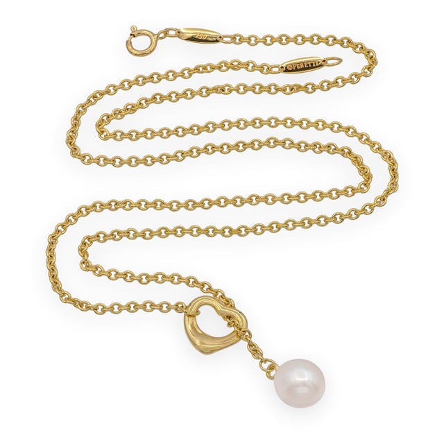 A refined and distinctive lariat necklace combining two of Elsa Peretti's most enduring design signatures — the Open Heart...