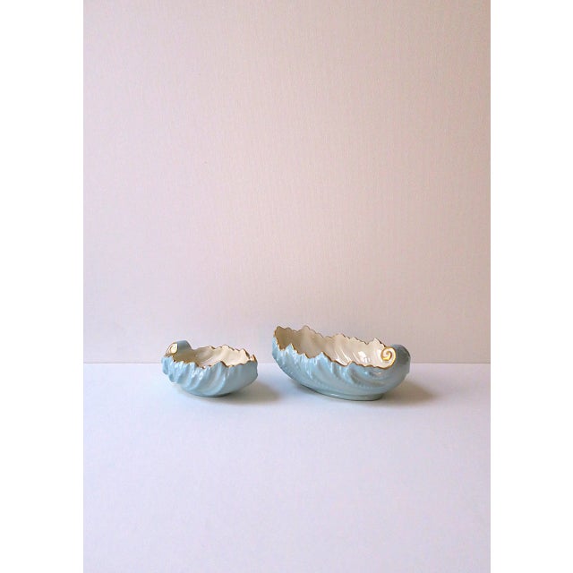 A beautiful set of two (2) porcelain bowls in powder blue with an acanthus leaf design finished with a gold edge and...