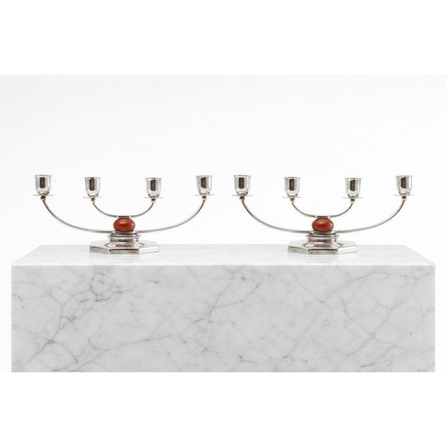 A beautifully balanced pair of four-arm silver-plated candelabra designed by danish sculptor and designer just andersen...