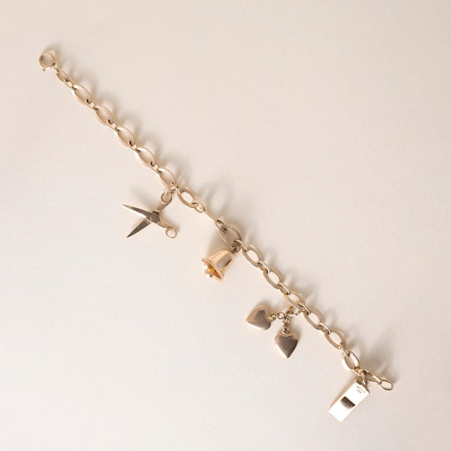 14K Yellow Gold charm bracelet Circa 1950s This delightful vintage charm bracelet from the 1950s captures the playful...