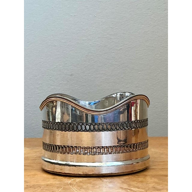 Combining functional utility with mid-century elegance, this vintage silver-plated wine coaster features a gracefully...