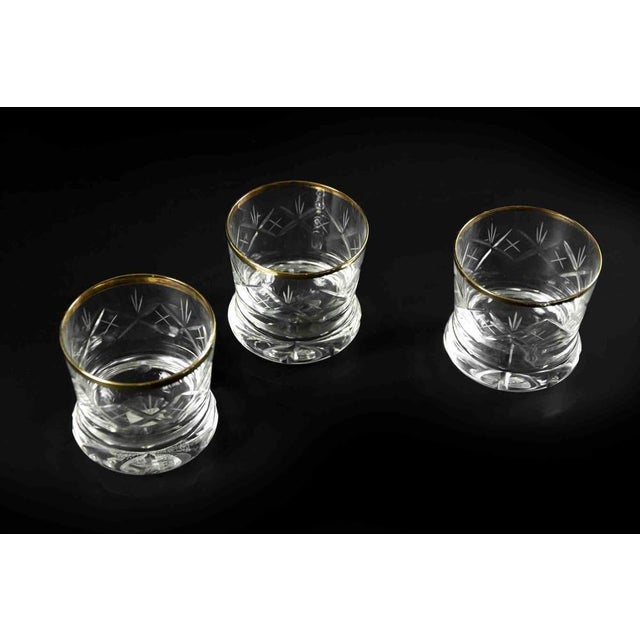 Set of three vintage glasses realized in Europe the half of 20th century. A beautiful set of three glasses with gilded edges.