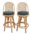 This is a handsome pair of 1970's Fick's Reed swivel bar stools. These are in a warm honey colored woven rattan stools...