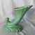 This item is a vintage mid-20th-century pastel green cornucopia (horn of plenty) art pottery vase, featuring a flared,...
