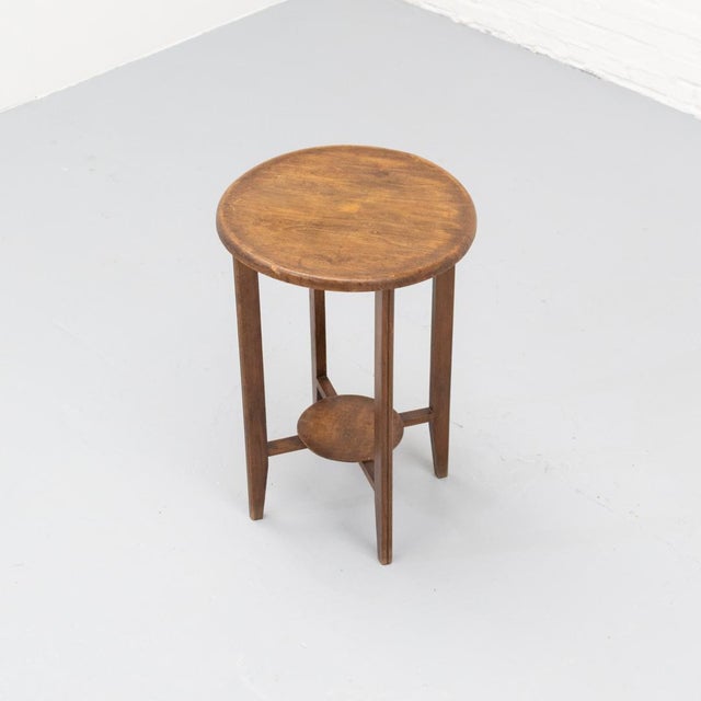 Side table from France dating to the 1920s, crafted from oak, identifiable by its warm brown tone and characteristic grain...