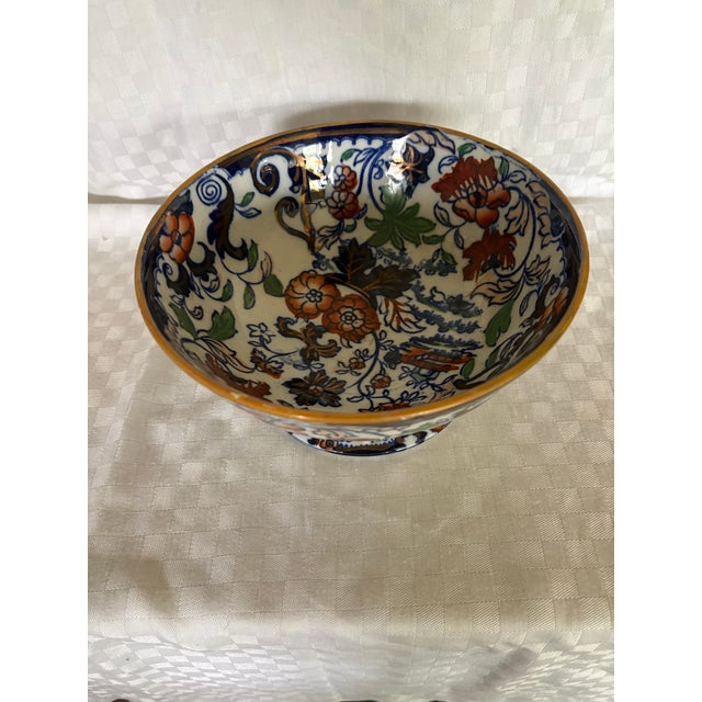 A 19th C English Imari footed bowl in the Amherst Japan pattern. The bowl has an overall design in a luster cobalt blue,...