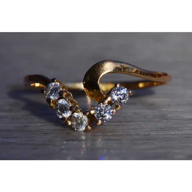 The Sasabe: Ladies 14K Yellow Gold Curved Ring set with Cubic Zirconia. This petite ring features five round cubic...