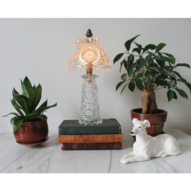 Vintage cut crystal boudoir table lamp with a matching crystal shade and brass acorn finial. Rotary switch on cord. No...
