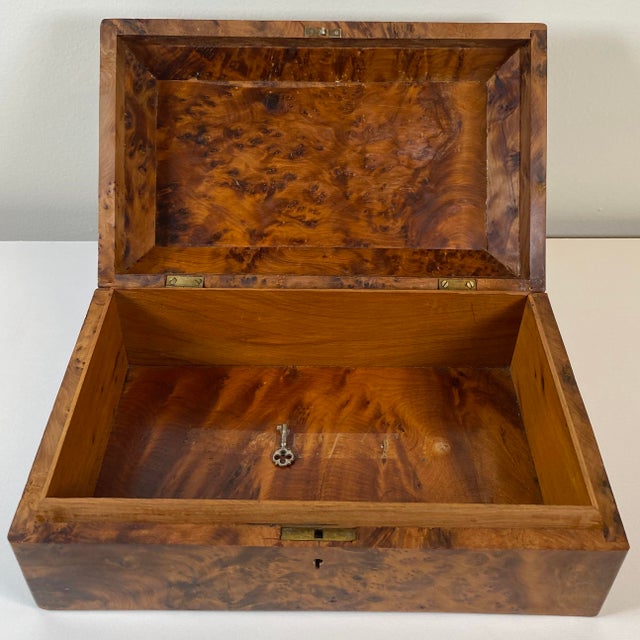 Embrace the timeless glamour of the 1930's with this exquisite French Art Deco jewelry box, handcrafted from amboyna wood....
