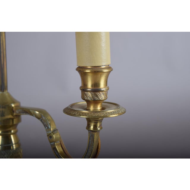 A beautifully classic French bouillotte table lamp in warm brass, featuring a refined two-light configuration and an...