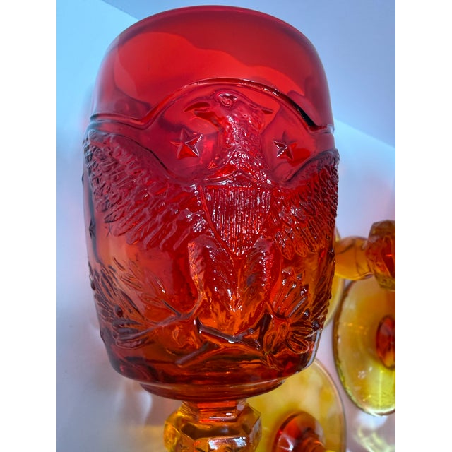 Set of six vintage amberina goblets featuring a bold American eagle, shield, and stars motif. These heavy pressed glass...