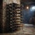 A French industrial-style metal wine rack dating from the early 20th century. The upper section of the rack includes...
