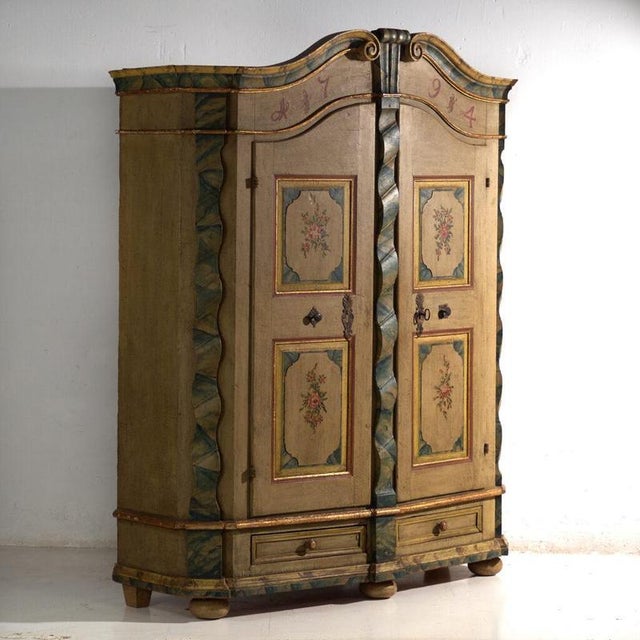 This antique baroque painted wardrobe in pine is a Central European two-door wardrobe with a shaped pediment, faux marble...