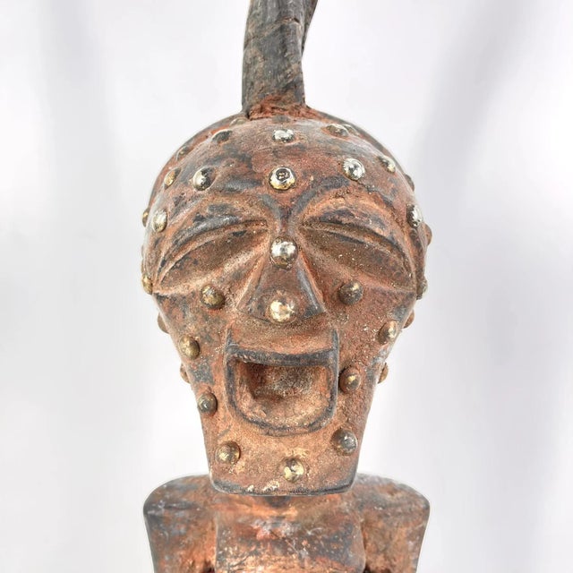 This intricately carved Songye standing figure exemplifies the distinctive artistic style of the Songye people,...