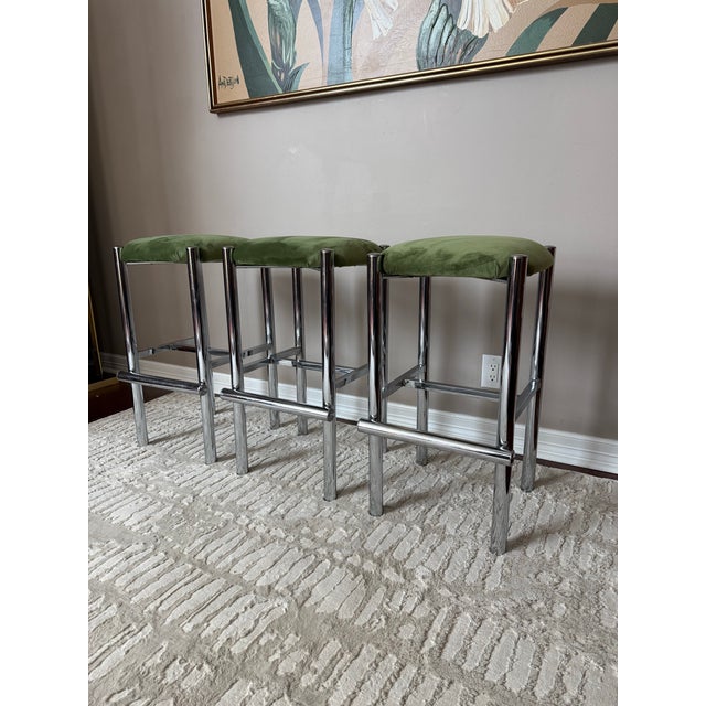 Gorgeous set of three Cal-style chrome framed counter height stools with brand new reupholstery in a soft olive green...