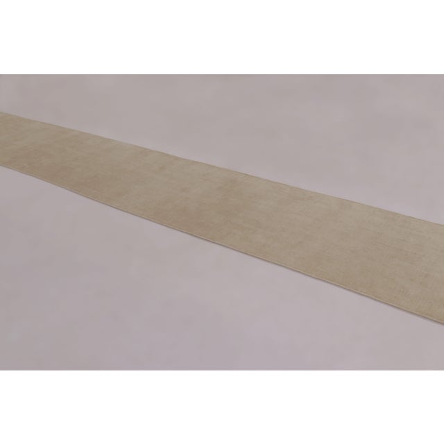 Made with a luxurious blend of silk, this 3x19 contemporary extra-long runner rug is a luminous masterclass in luxury,...