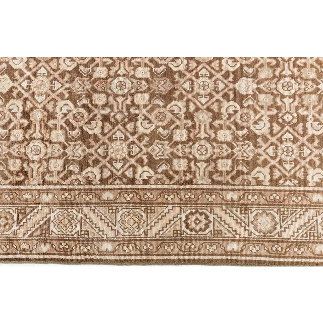 This antique Persian Malayer runner from the 1920s showcases the artistic nuance and technical skill typical of Malayer...