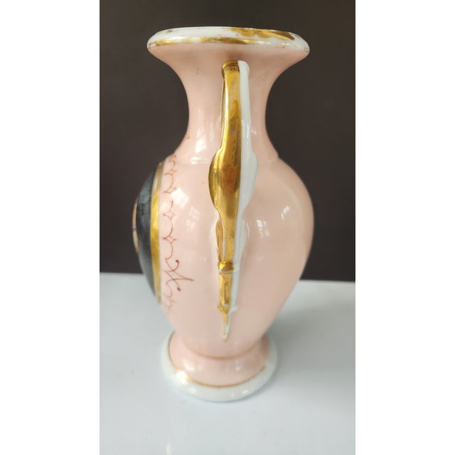 A late Victorian porcelain vase, likely Bohemian, dating to circa 1900. The piece features a blush pink ground, hand-...
