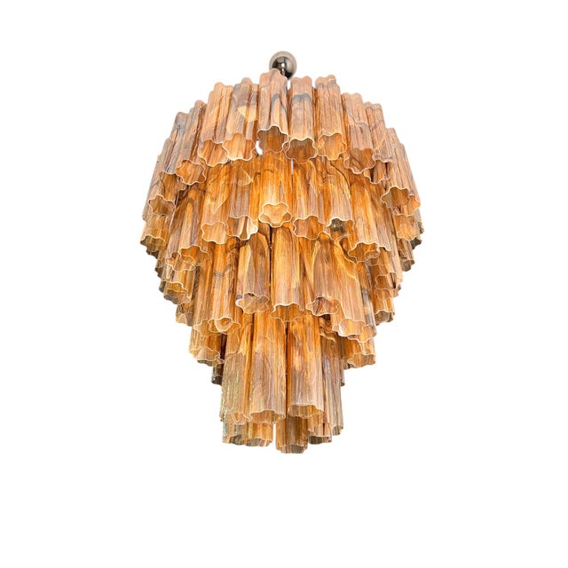 Authentic Murano glass chandelier featuring a dramatic cascading structure composed of handcrafted vertical elements. The...