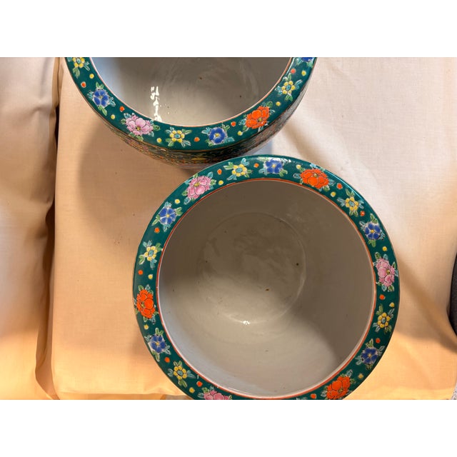 Pair of large Japanese porcelain planters with intricate designs. Detailed decoration.