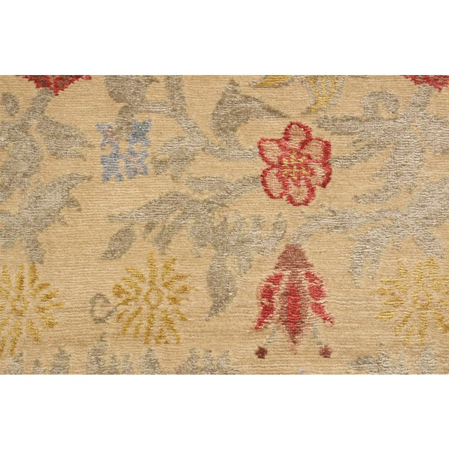 Hand knotted in Nepal, this floral runner features a Bilbao floral design, hand knotted in a lustrous combination of wool...
