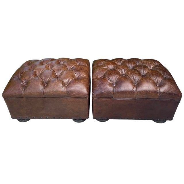 Pair of Restoration Hardware tufted leather ottomans featuring distressed cigar brown leather upholstery, deep button...
